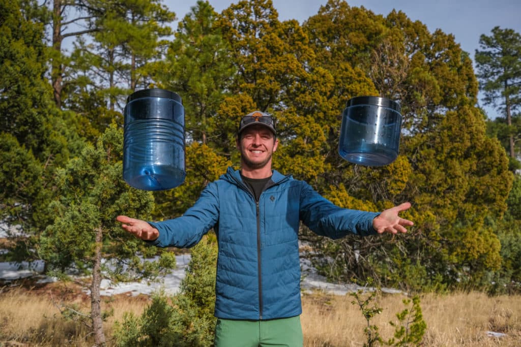 Man tossing two BearVault canisters into the air