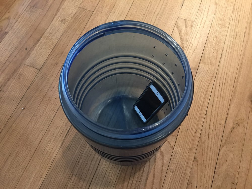 An iPhone propped inside a bear canister to amplify alternative sounds