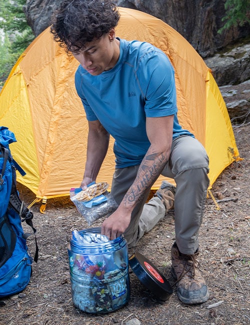 Young man camping and using the BV475