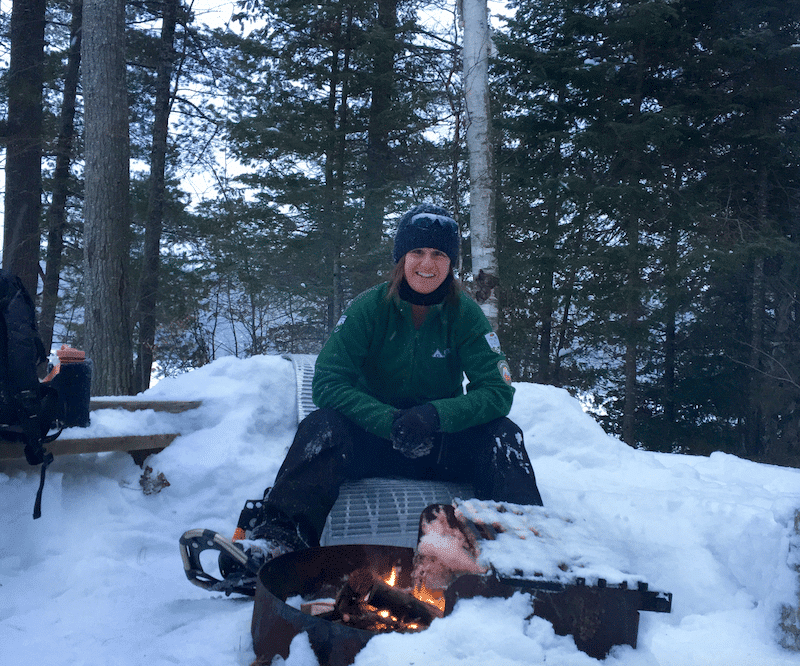 Woman sitting in snow camping