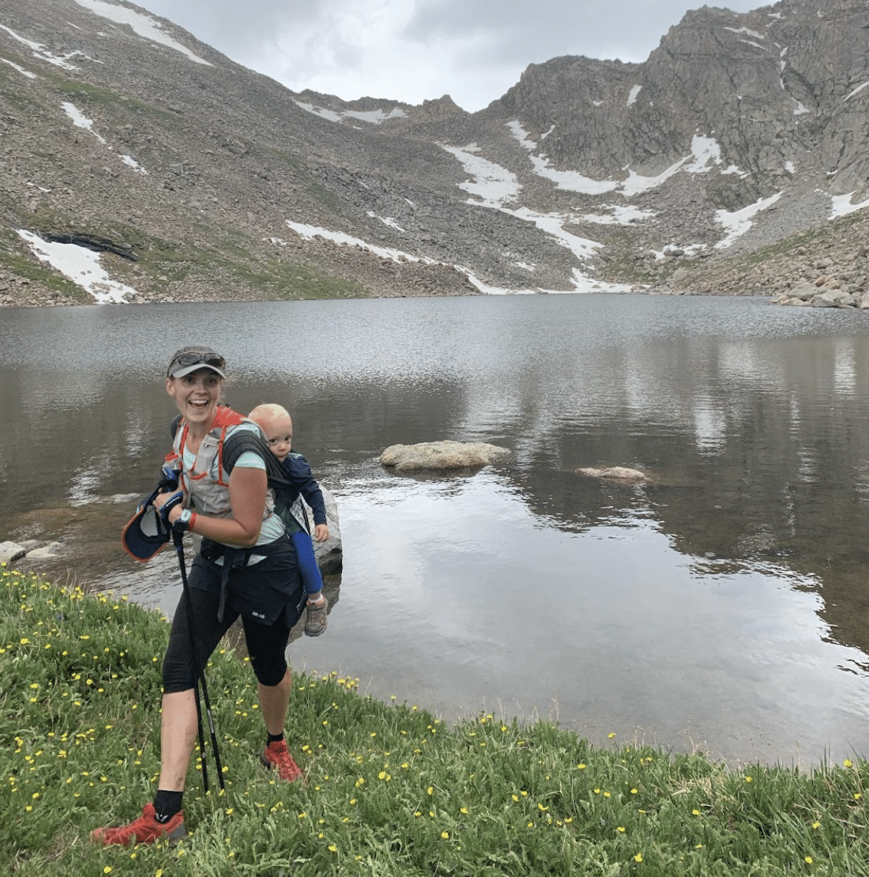 Jennifer D with her child in front of a beautiful alpine lake in Colorado.