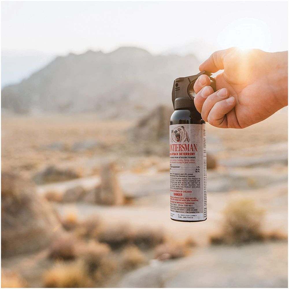 An image of a bear spray canister about to be discharged in the desert.