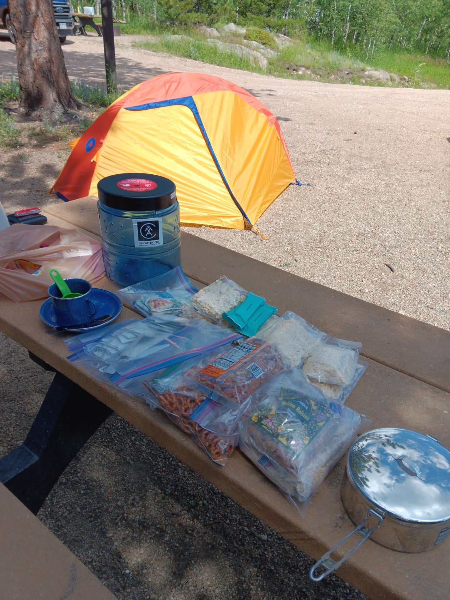 Backpacking supplies on a picnic table.