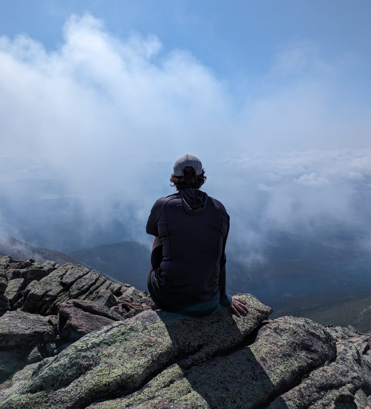 An Appalachian Trail hiker takes in the view from a high peak.