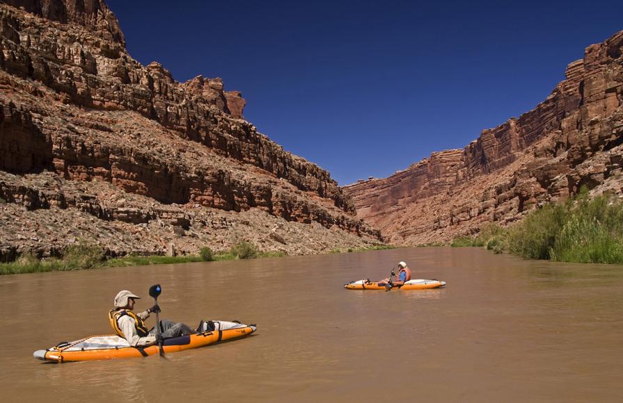 A group of kayakers float down the San Juan river in Utah.