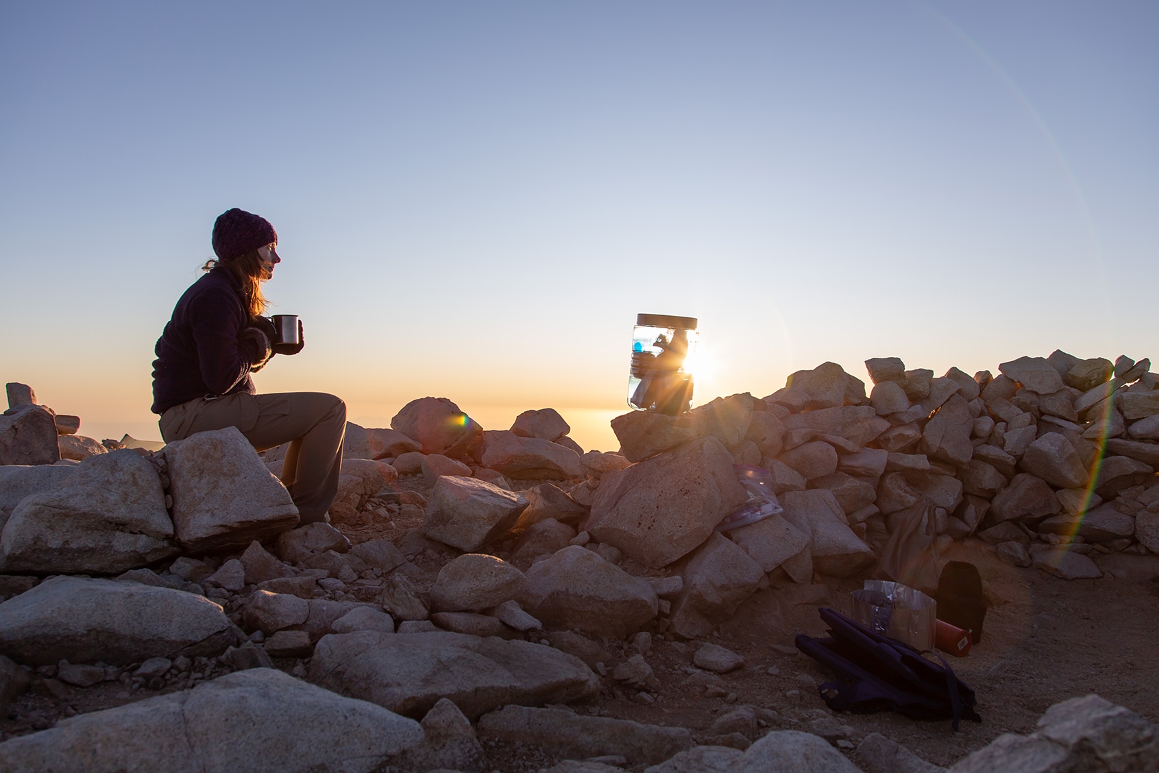 A hiker enjoying dinner with their BearVault near Mt. San Jacinto.